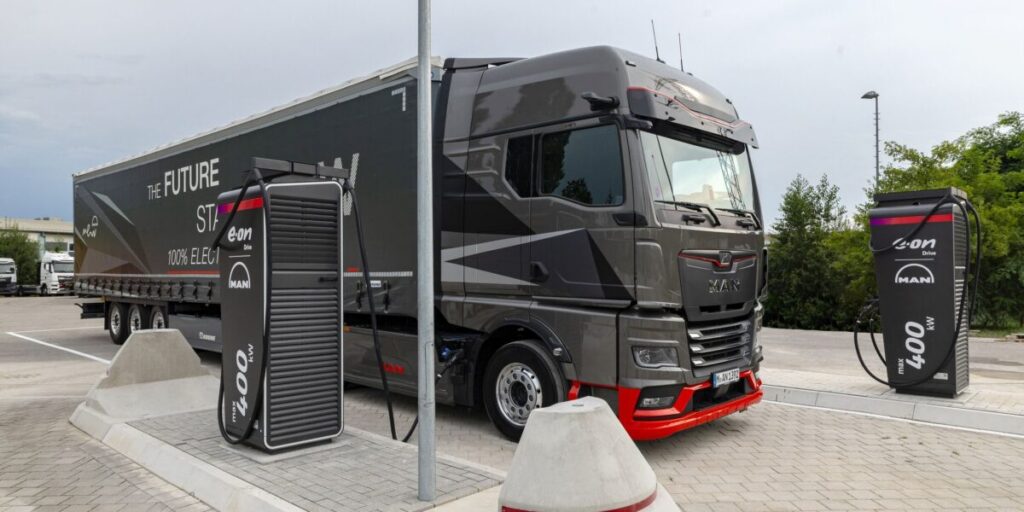 Ein elektrischer Lkw steht zwischen zwei Schnellladestationen von Alpitronic.