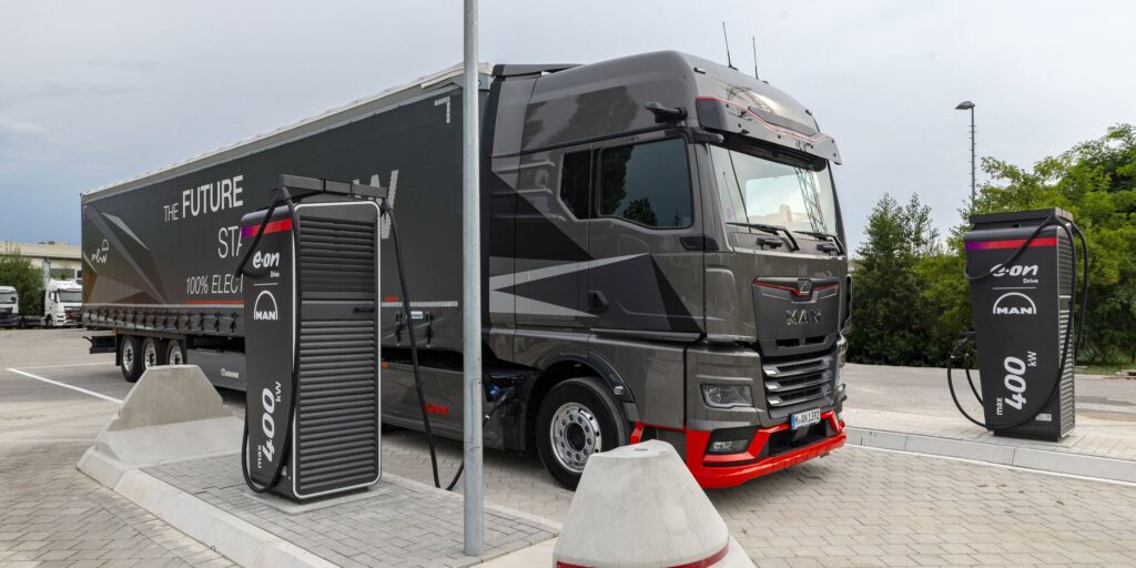 Ein elektrischer Lkw steht zwischen zwei Schnellladestationen von Alpitronic.