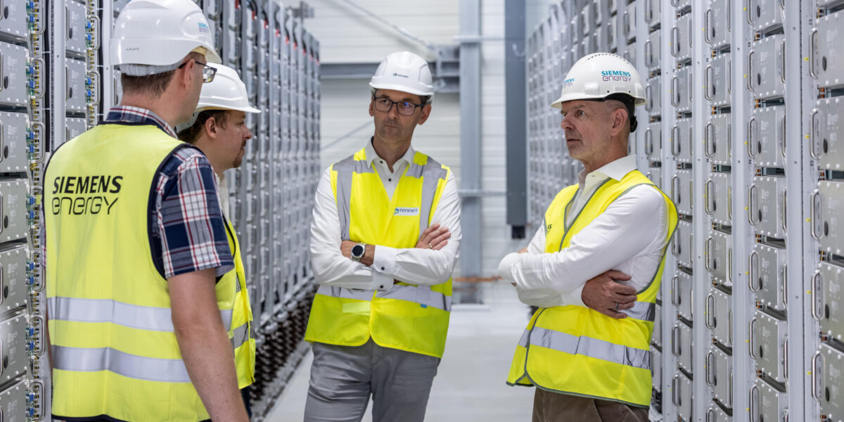 Menschen im Raum. Silbern industriell mit racks voller Superkon densatoren